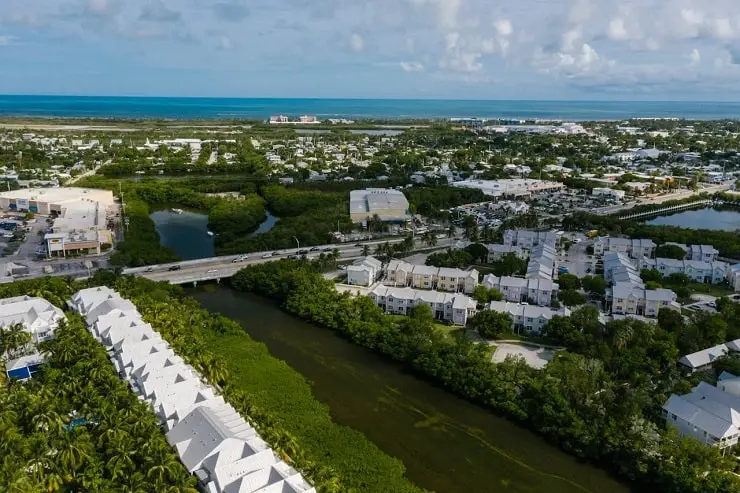 Aerial view of a Florida neighborhood with homes, possibly part of a homeowners association (HOA), showcasing organized and well-maintained properties.